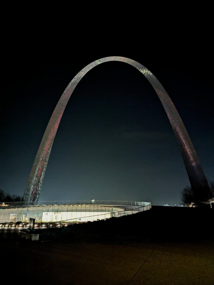 The Gateway Arch photographed at night against a black sky